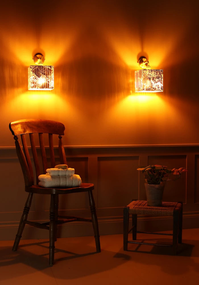 Square gold leaf IP44 bathroom wall lights with wooden chair, bath towels and plant