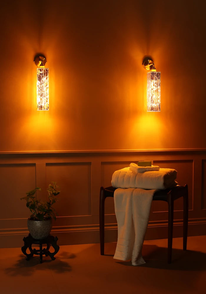 Elegant long ribbed glass ip44 gold leaf bathroom wall light, bath towels, plant