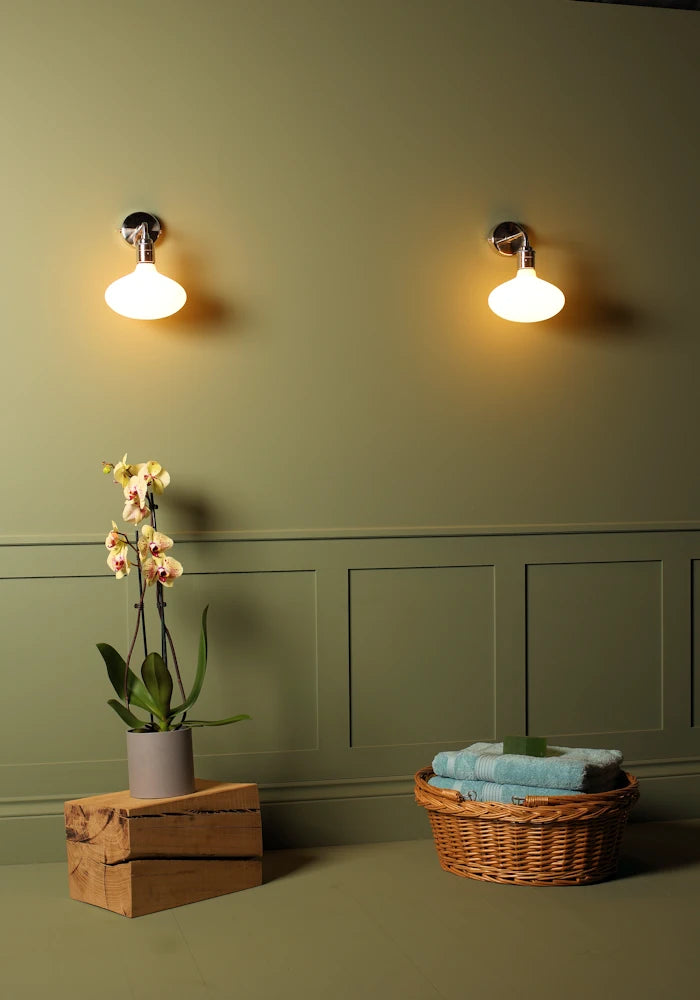 Elegant Tala Oval IP44 bathroom wall lights, exotic plant, basket with bath towels