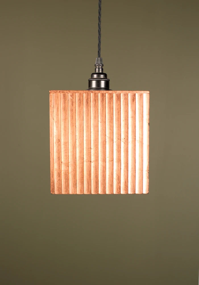 Square copper pendant light with bronze lamp holder or a green background