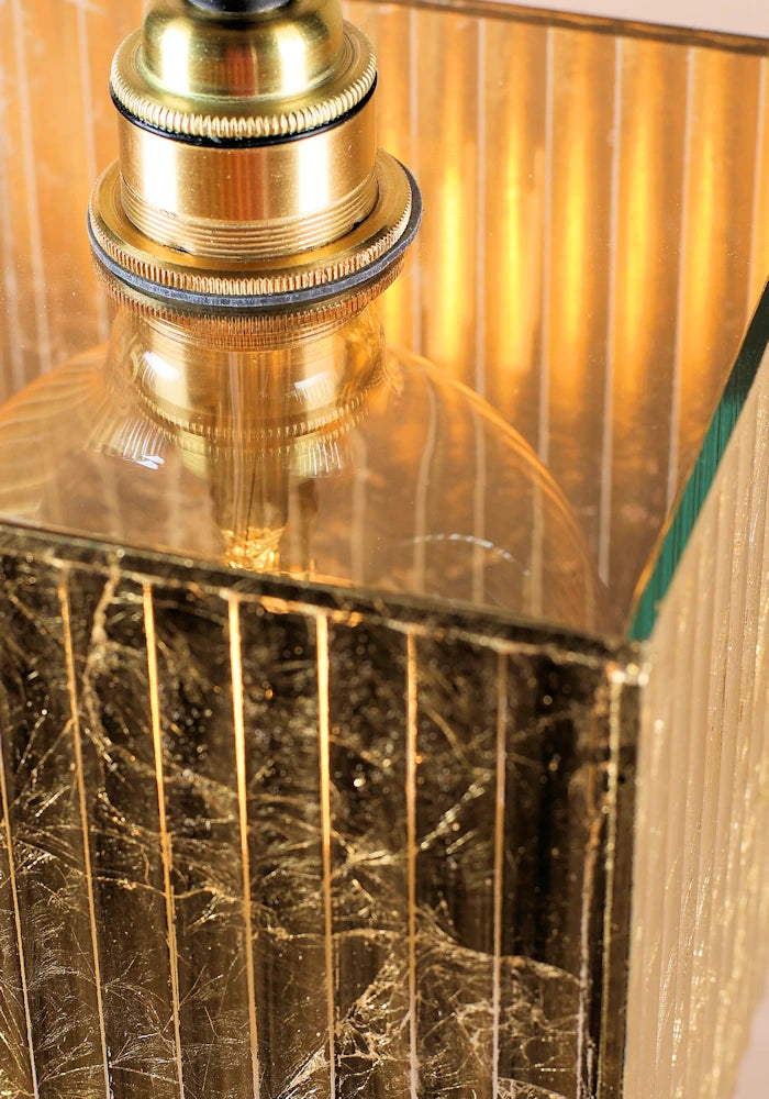 Close up of gold leaf pendant light with brass lamp holder