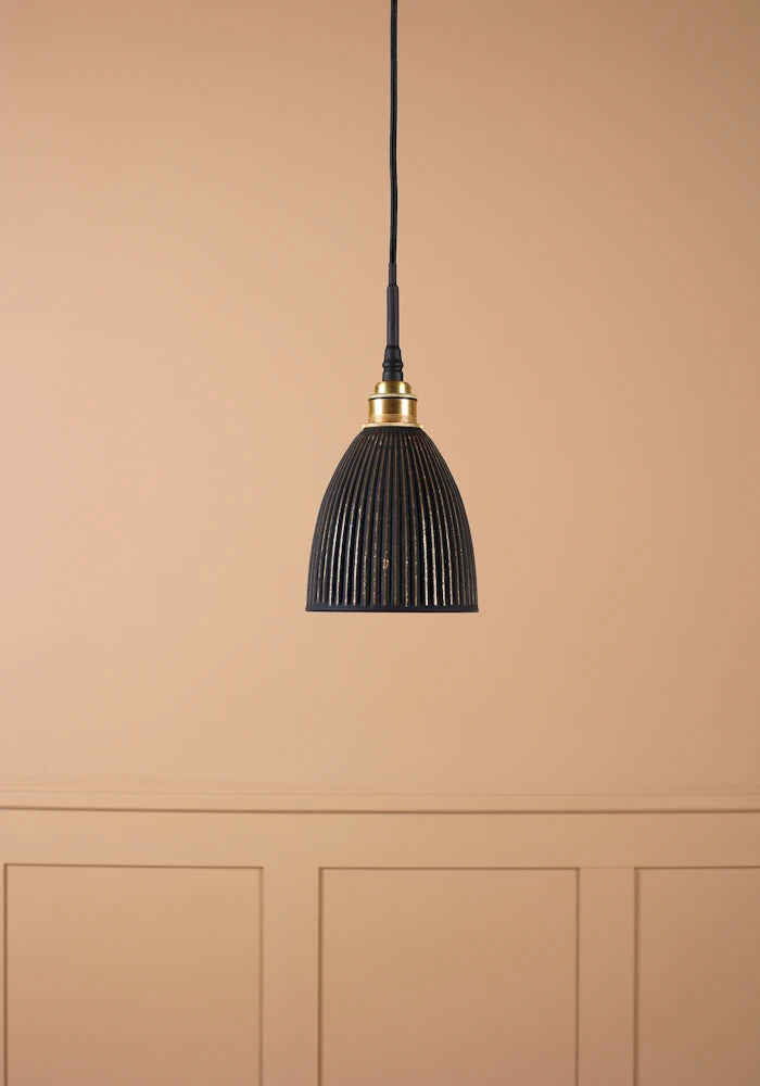 Small bell shaped black and gold ribbed bathroom pendant light with brushed brass lamp holder and black fabric flex.
