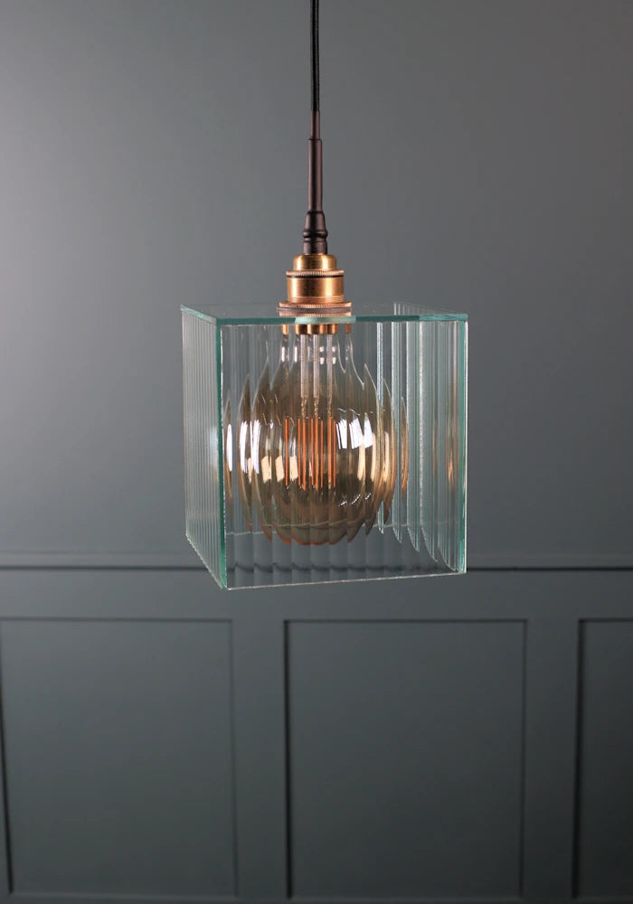 Square ribbed glass bathroom pendant light with brushed brass lamp holder.