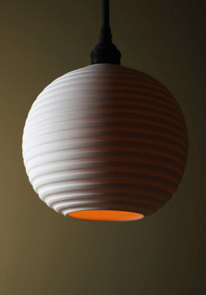 Close up of spherical porcelain bathroom pendant light