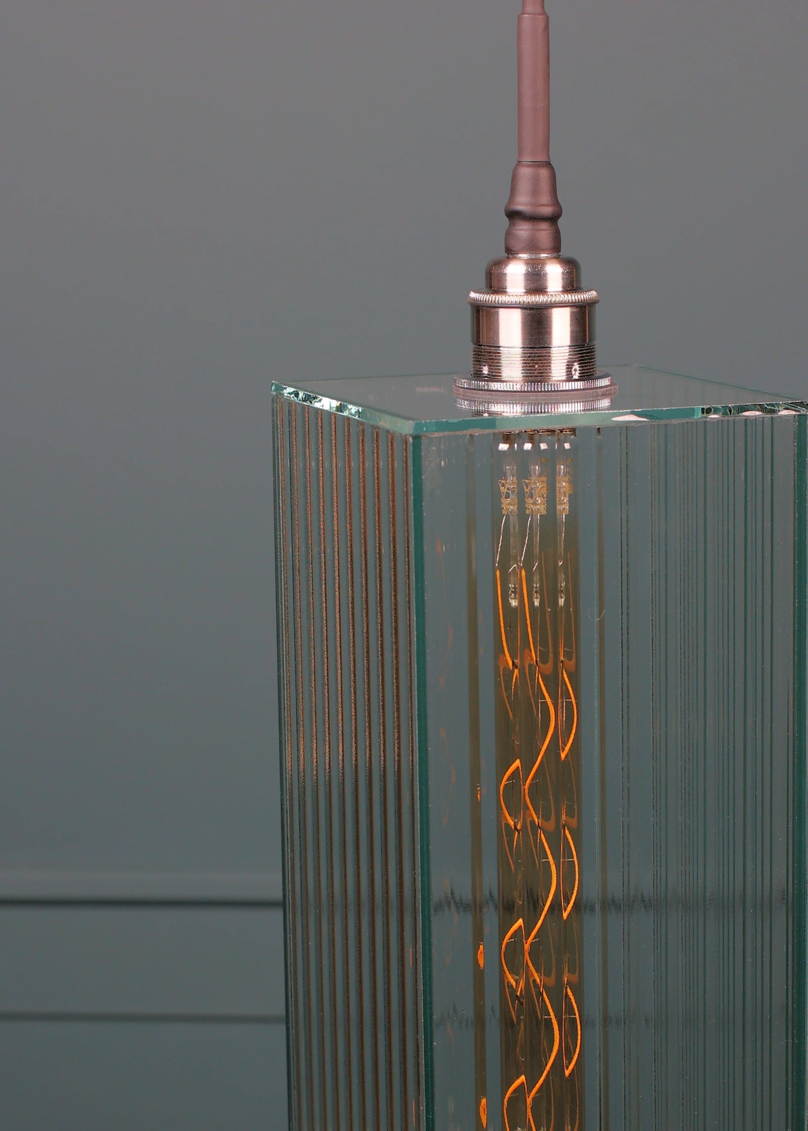 Large ribbed glass bathroom pendant light with brushed nickel lamp holder.