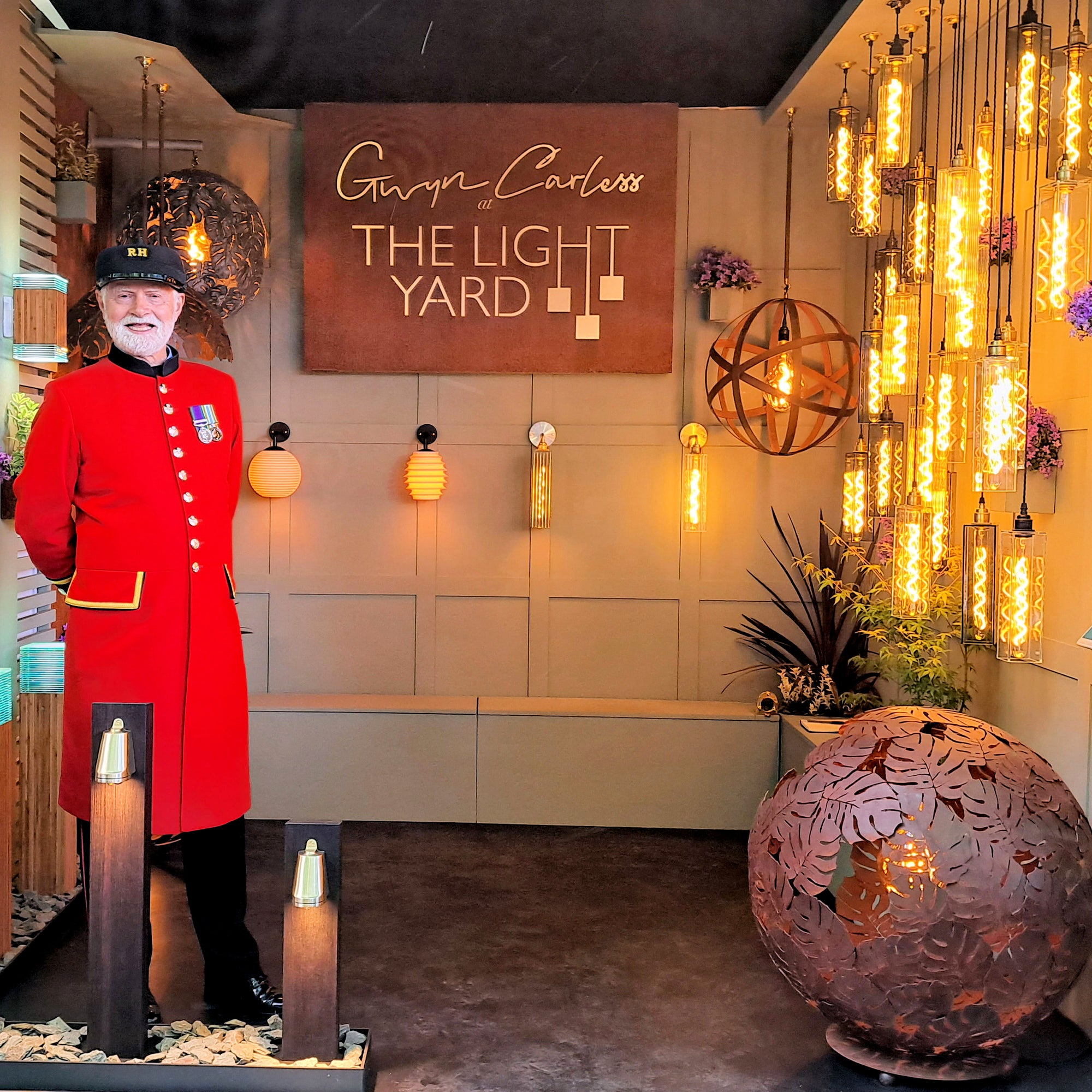 Gwyn Carless At The Light Yard, RHS Chelsea Flower Show, Jardin Blanc & Raymond Blanc Chef, image of a Chelsea pensioner on trade stand