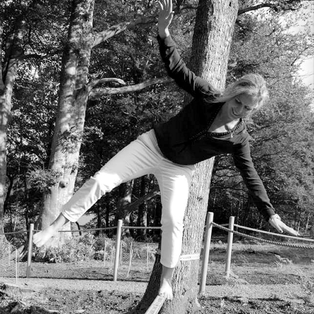 Bookkeeper for The Light Yard balancing on a log