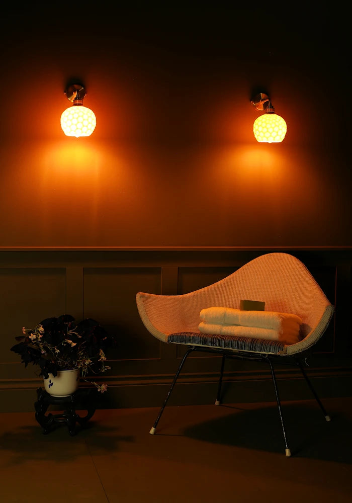 Elegant honeycomb effect ceramic IP44 bathroom wall lights, art deco chair, bath towels, pot plant