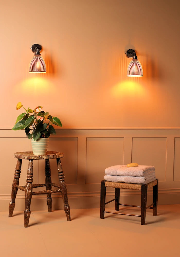 Elegant small bell fluted glass IP44 bathroom wall lights, stool with plant, bath towels