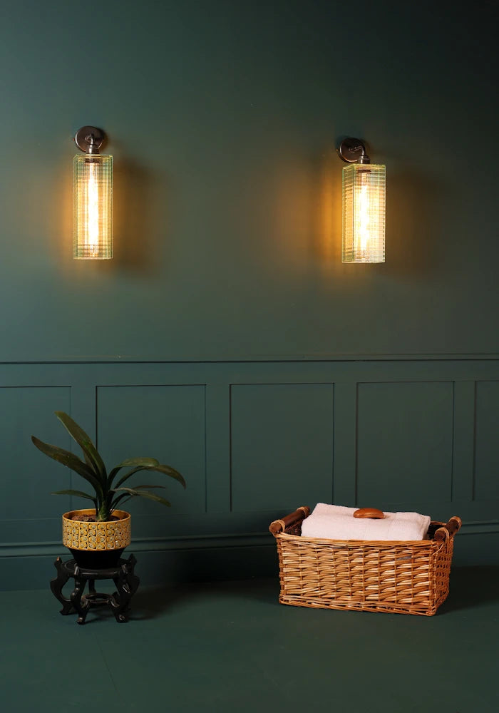 Elegant art deco glass IP44 bathroom wall lights, bath towels in basket, pot plant