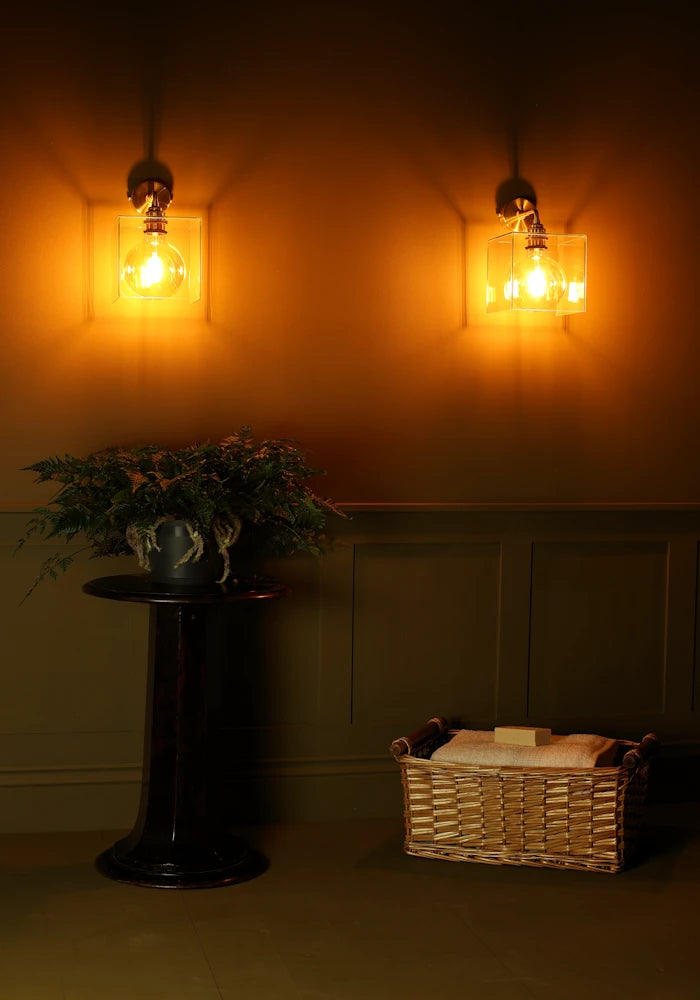 Elegant square glass IP44 bathroom wall lights with plant and bath towels 