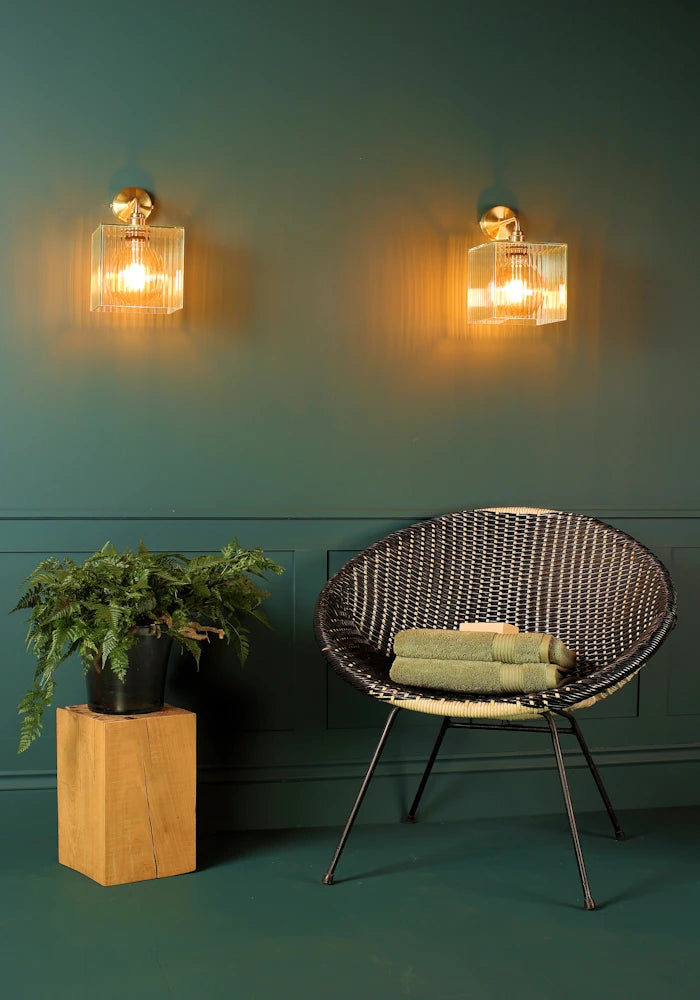 Elegant square ribbed glass IP44 bathroom wall lights, art deco chair with bath towels, pot plant