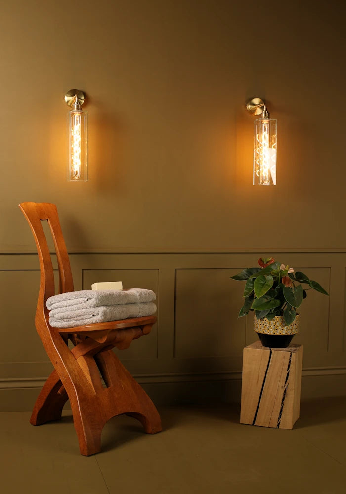 Elegant glass IP44 bathroom wall lights, wooden chair with bath towels, pot plant