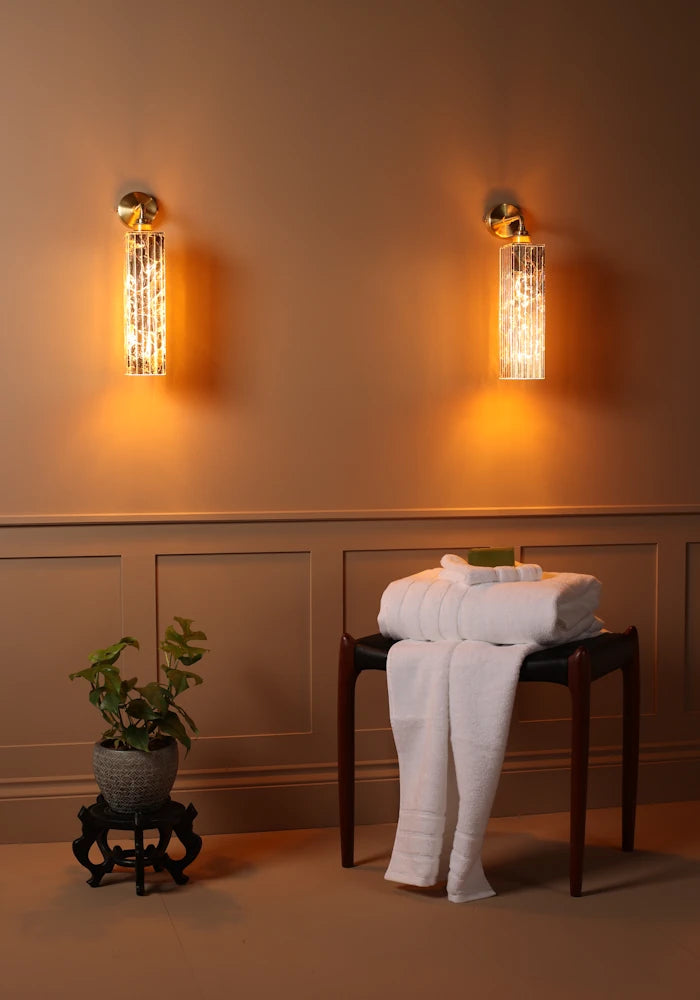 Elegant long ribbed glass ip44 gold leaf bathroom wall light, bath towels, plant