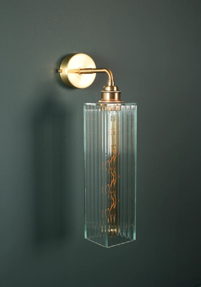 Elegant long fluted glass IP44 bathroom wall light with brass fixtures