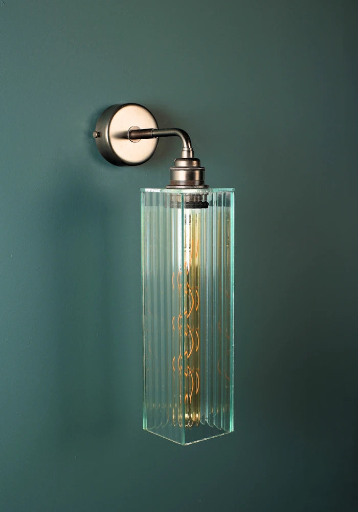 Elegant long fluted glass IP44 bathroom wall light with bronze fixtures