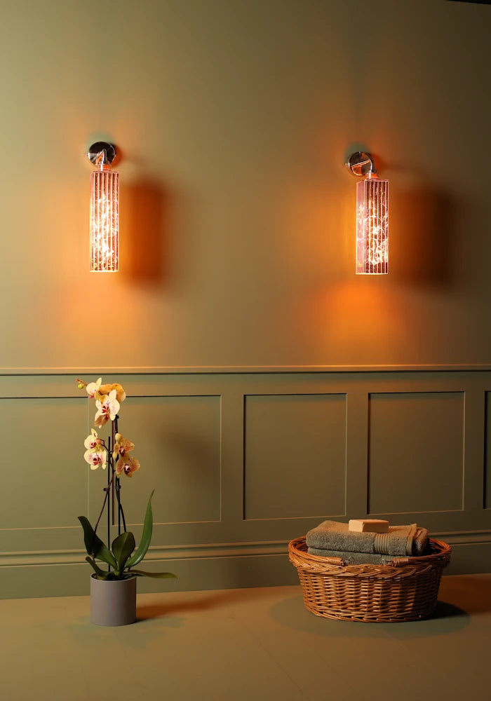 Elegant copper IP44 bathroom wall lights, basket of bath towels, exotic plant