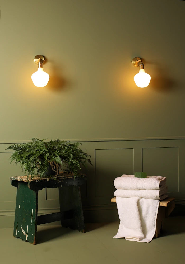 Elegant Tala Enno IP44 bathroom wall lights, pot plant, bath towels