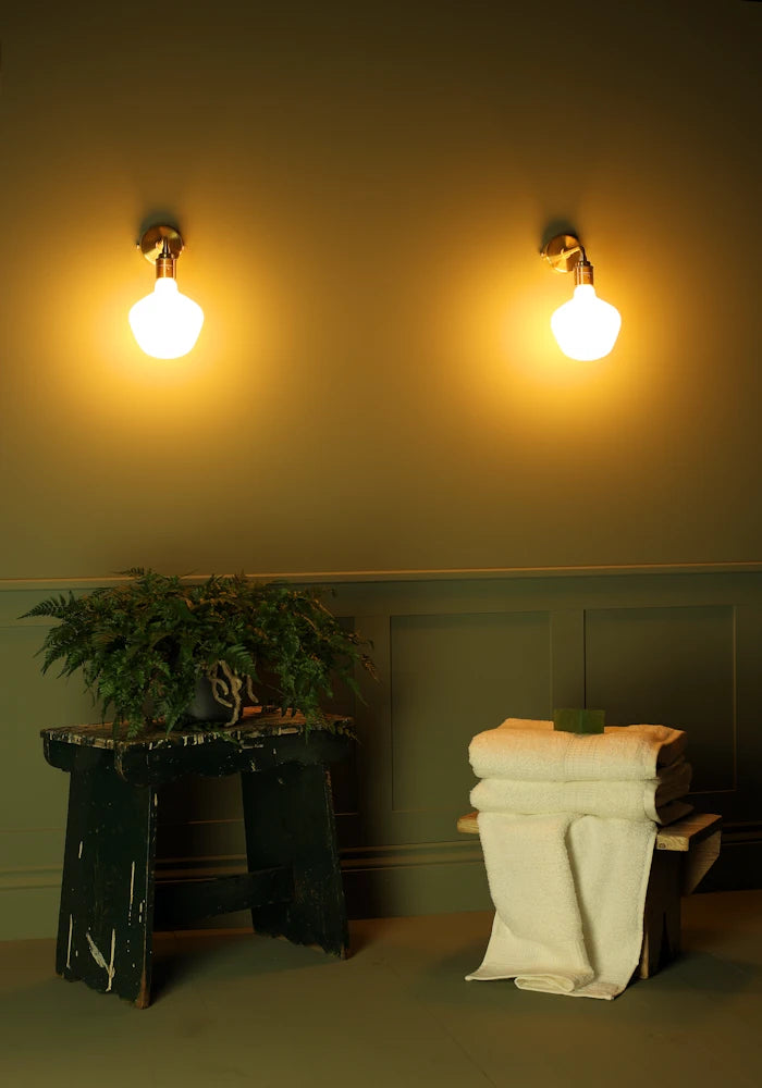 Elegant Tala Enno IP44 bathroom wall lights, pot plant, bath towels