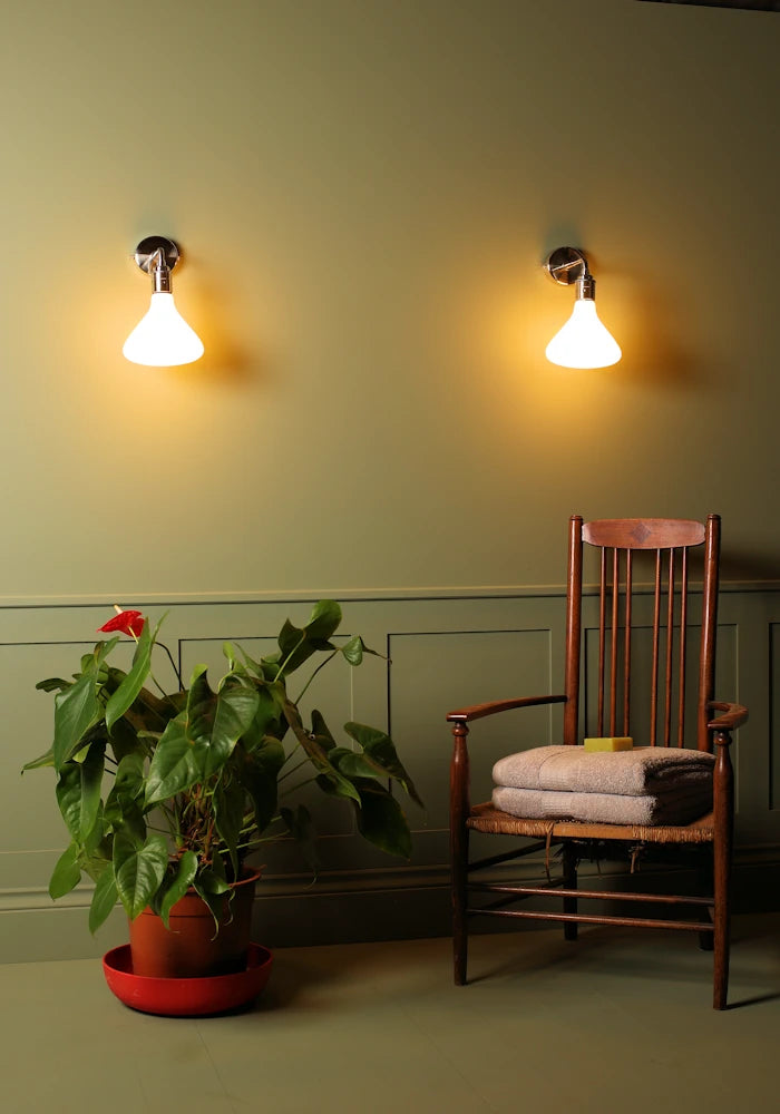 Elegant Tala Noma IP44 bathroom wall lights, large pot plant, vintage wooden chair with bath towels