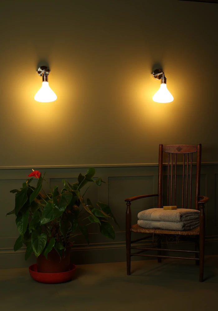 Elegant Tala Noma IP44 bathroom wall lights, large pot plant, vintage wooden chair with bath towels