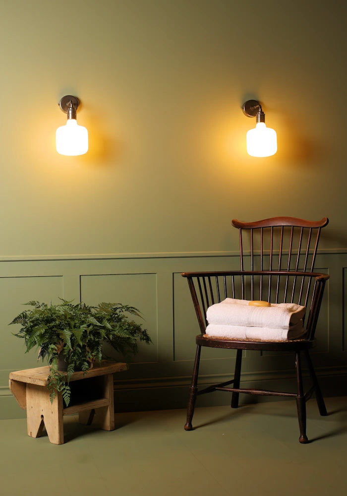 Elegant Tala Oblo IP44 bathroom wall lights, pot plant, vintage wooden chair with bath towels