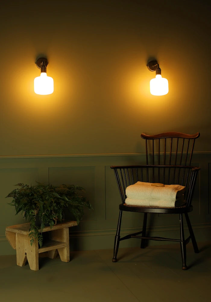 Elegant Tala Oblo IP44 bathroom wall lights, pot plant, vintage wooden chair with bath towels