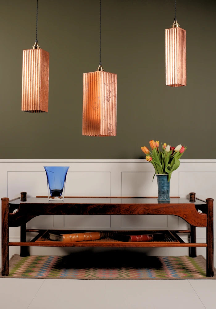 3 large copper leaf pendant cluster lighting feature, rug, wooden coffee table and vase with tulips