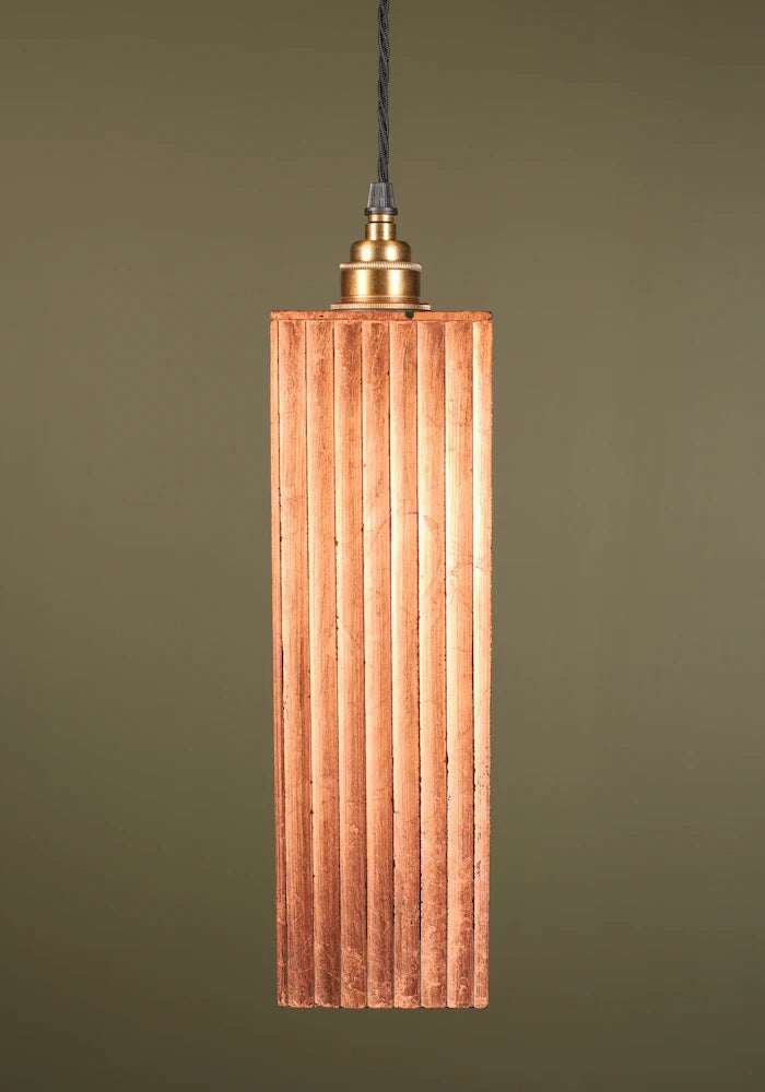 Copper leaf pendant light with brass lamp holder on sage green background