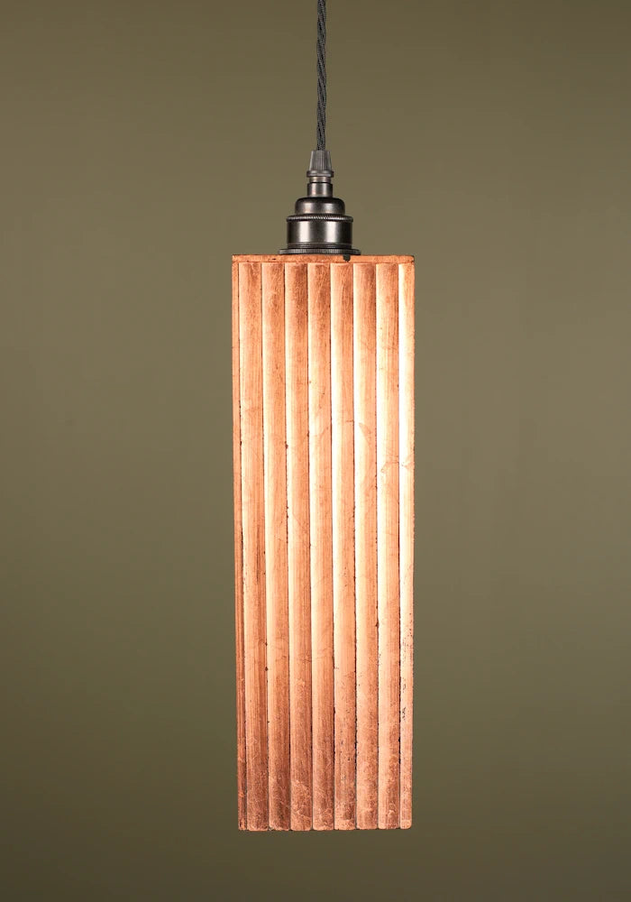 Copper leaf pendant light with bronze lamp holder on sage green background