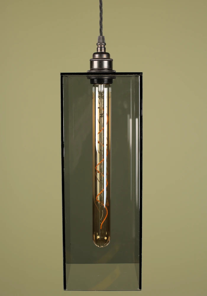 Pendant light with a smoked glass shade and bronze lamp holder on a plain background.