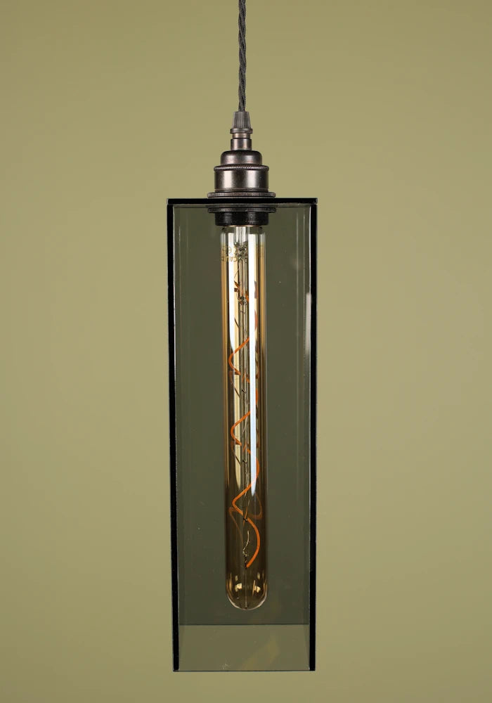 Mid size smoked glass pendant light with bronze lamp holder on sage green background