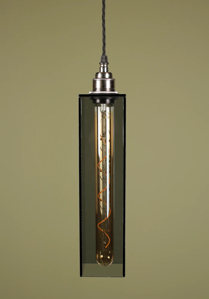 Smoked glass pendant light with nickel lamp holder, exposed bulb on sage green background 