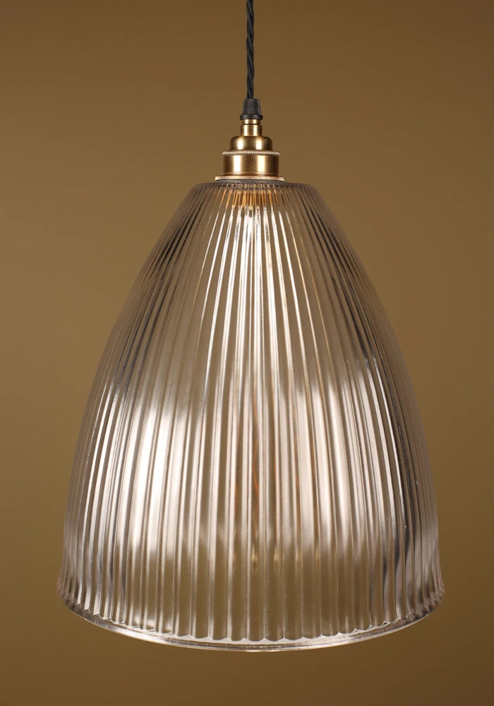 Large statement ribbed glass pendant light with brass lamp holder, beige background