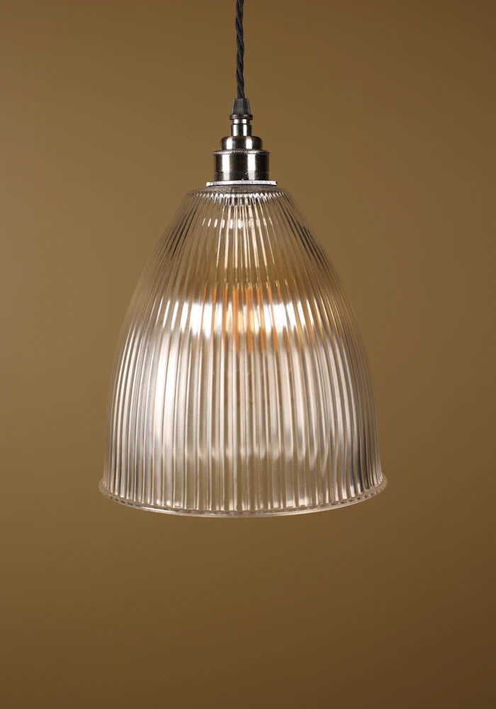 Bell shaped prismatic glass pendant light with nickel lamp holder on beige background