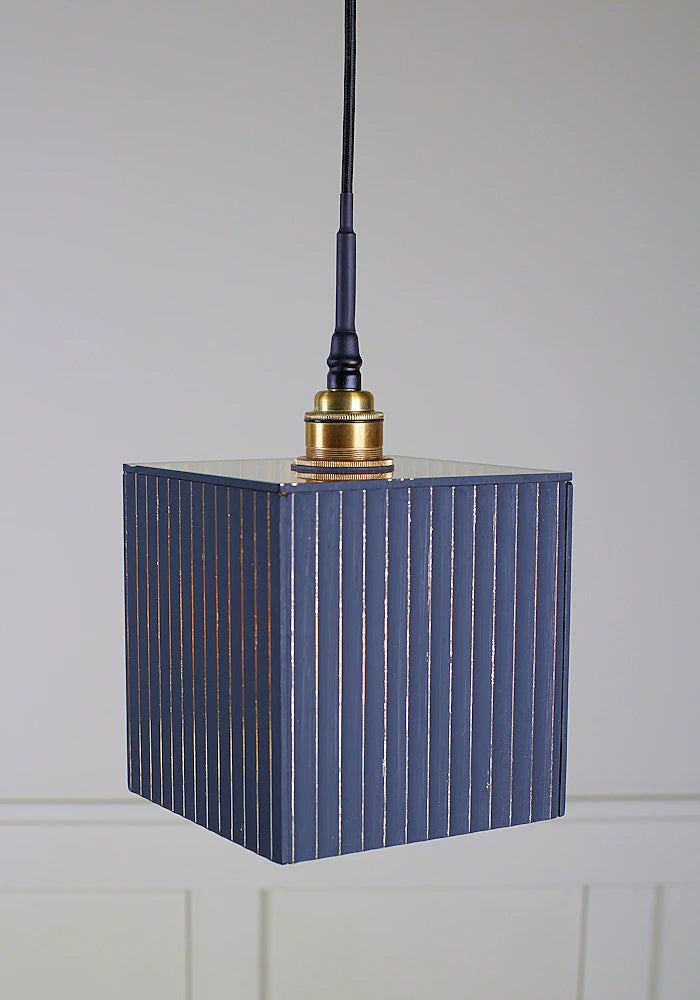 Black and gold ribbed glass bathroom pendant light with brushed brass lamp holder and black fabric flex.