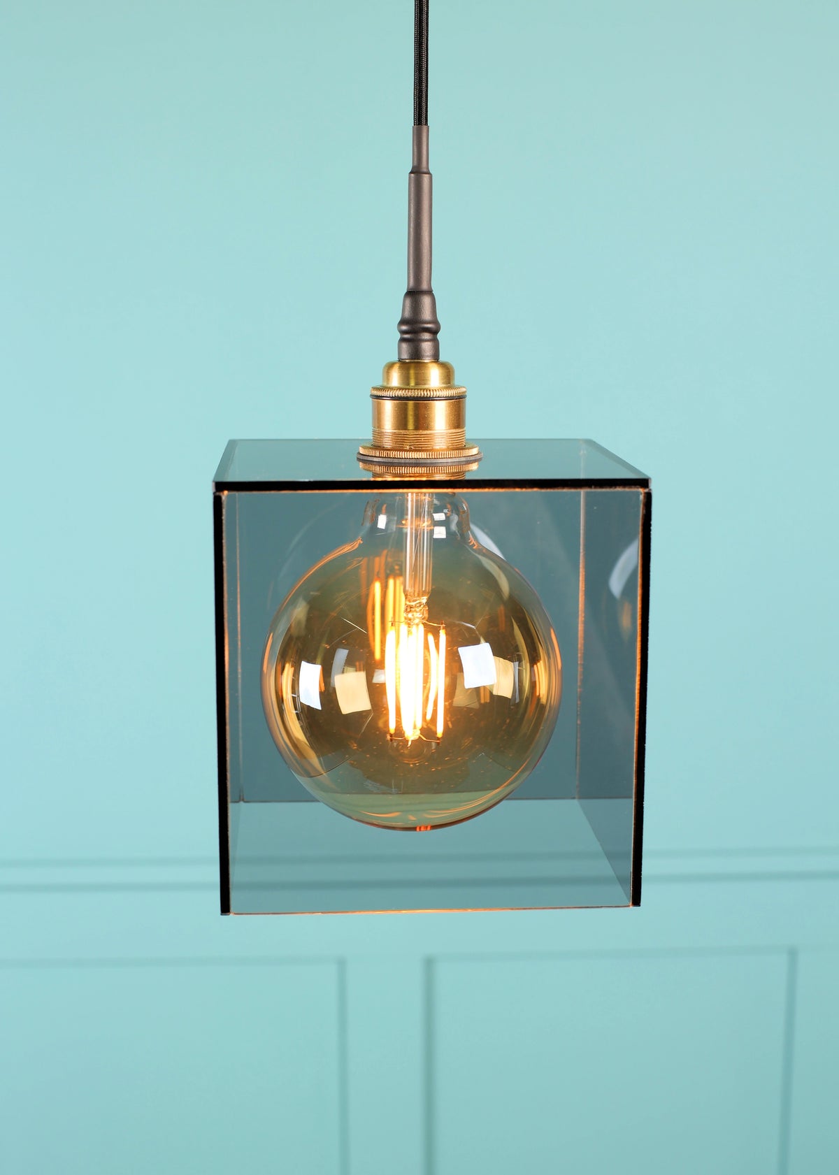 A smoked glass square pendant light brass lamp holder and Edison style light bulb