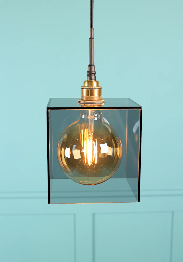 Large square smoked glass bathroom pendant light with brushed brass lamp holder.