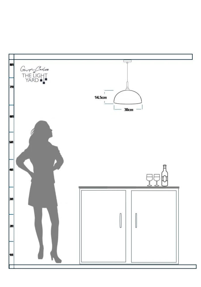 Silhouette of woman looking up a dome shaped pendant light hanging over kitchen cabinets 