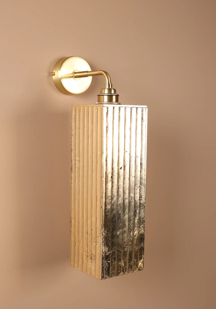 Elegant large ribbed glass ip44 gold leaf bathroom wall light close up with brass wall plate 
