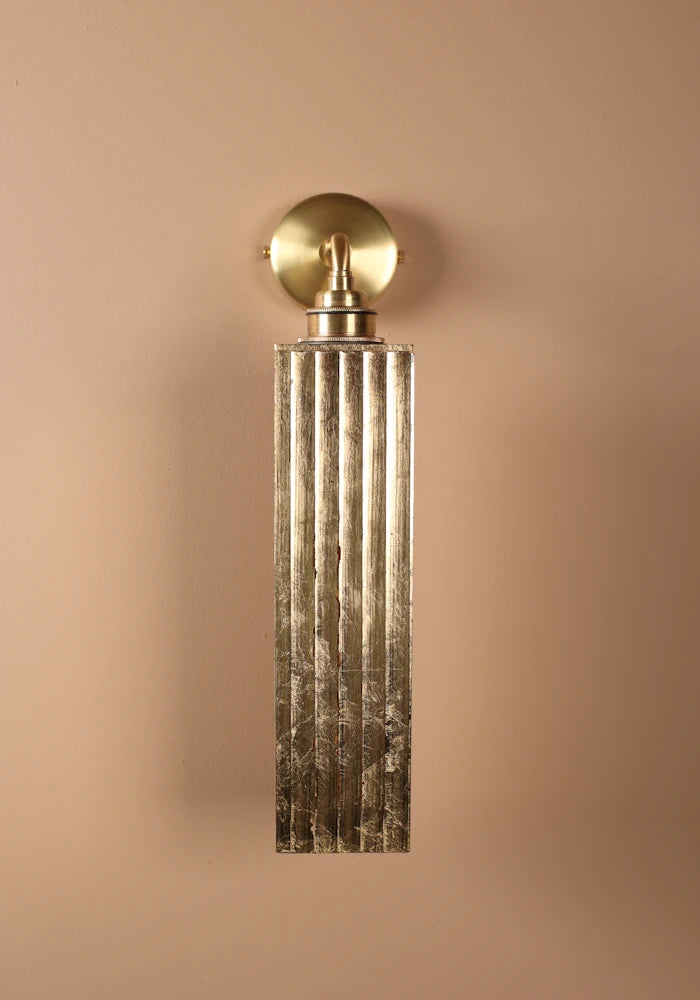 Elegant long ribbed glass ip44 gold leaf bathroom wall light close up with brass wall base