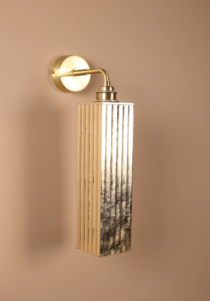 Elegant long ribbed glass ip44 gold leaf bathroom wall light close up with brass wall base