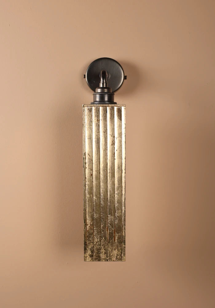 Elegant long ribbed glass ip44 gold leaf bathroom wall light close up with bronze wall base