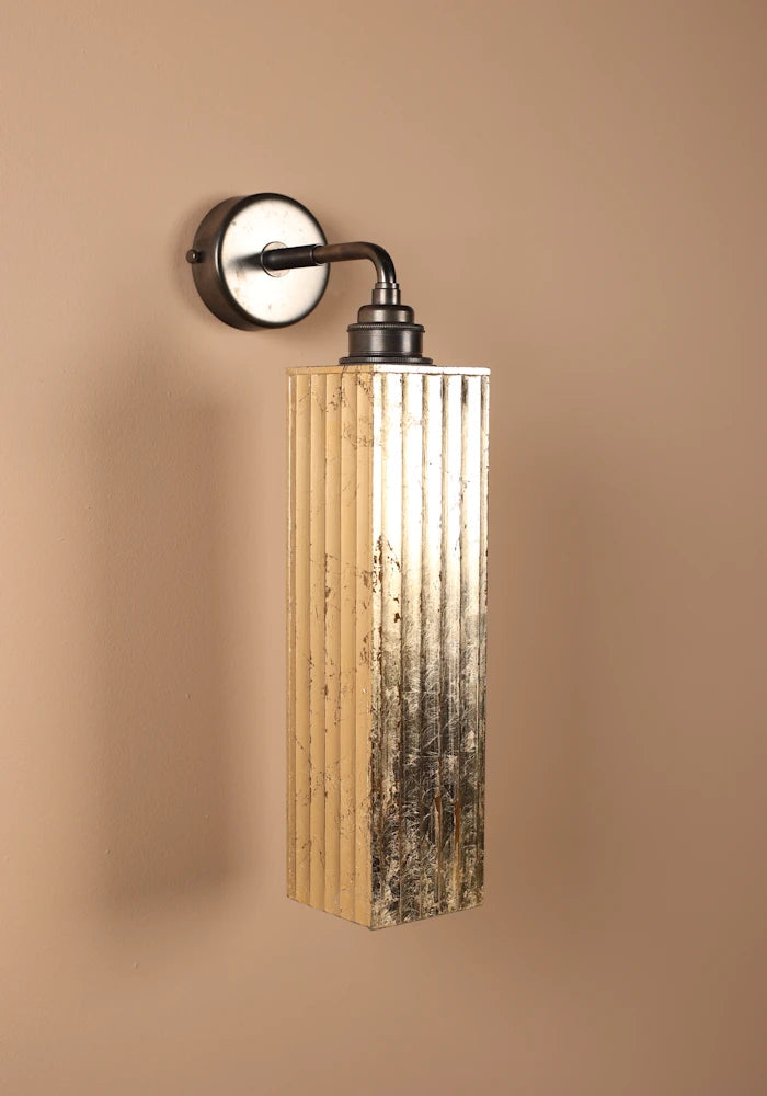 Elegant long ribbed glass ip44 gold leaf bathroom wall light close up with bronze wall base