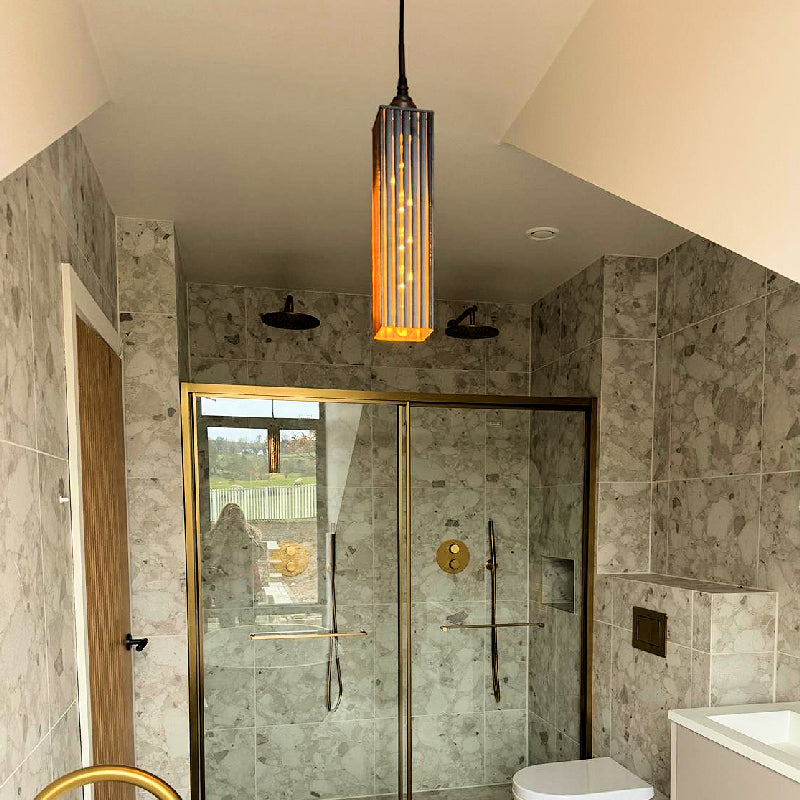 Black and gold bathroom pendant light hanging in modern bathroom