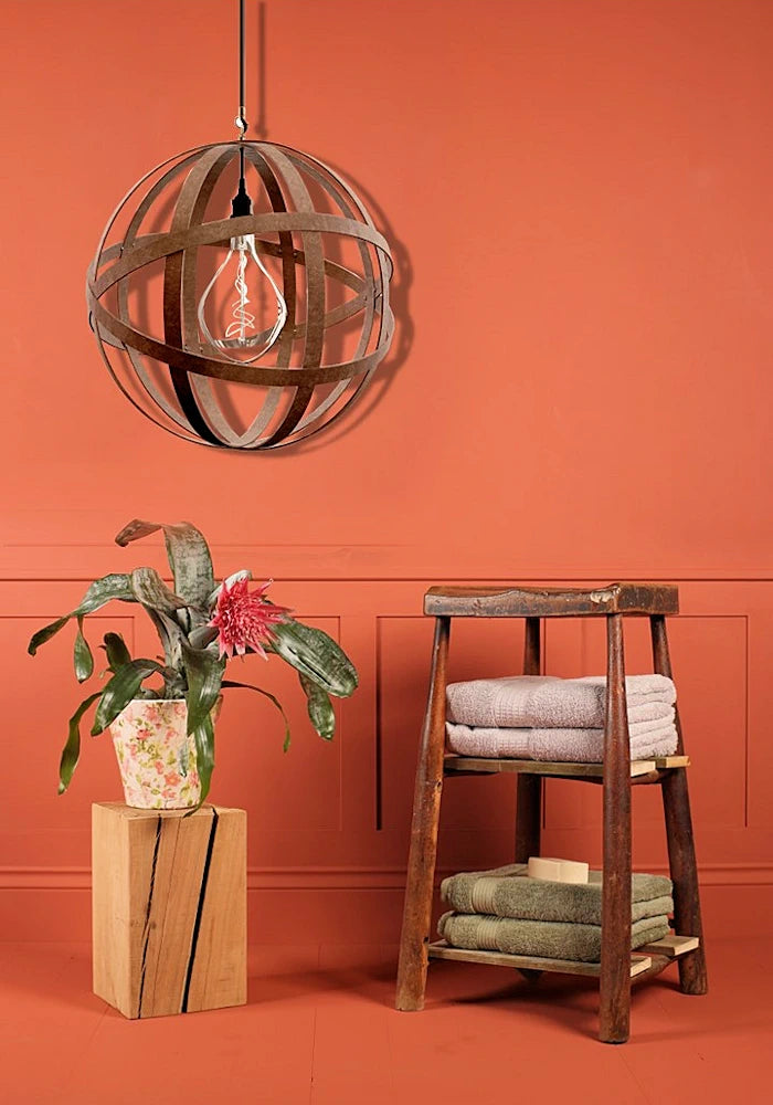 Orbital industrial style bathroom pendant light, plant and wooden stool with bath towels.