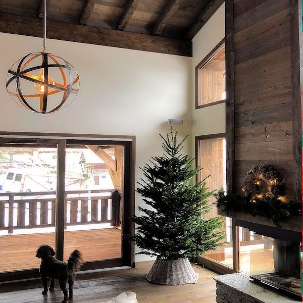 Decorative Orbital pendant light hanging in wooden chalet with dog and Christmas tree