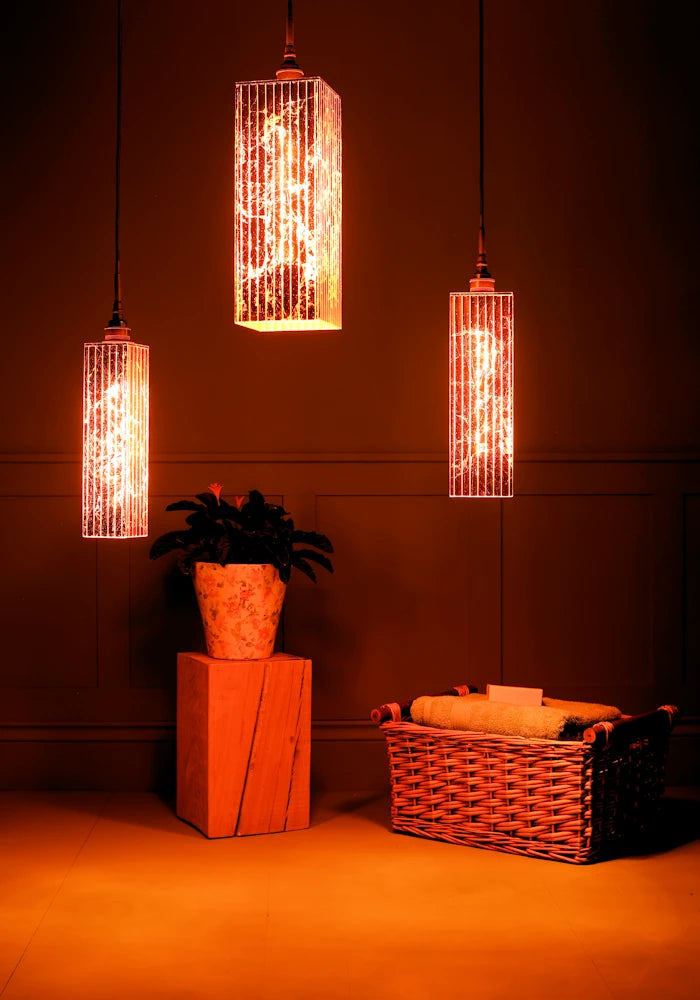 Large triple rectangular copper leaf cluster bathroom pendant light, plant and basket of bath towels. 