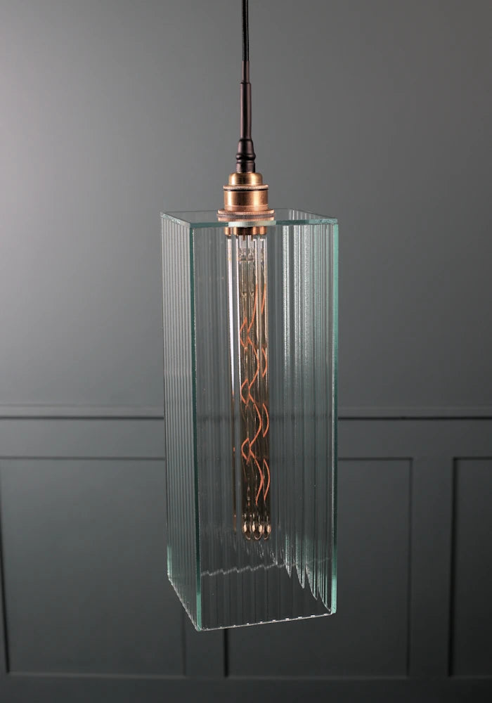 Large rectangular ribbed glass bathroom pendant light with brushed brass lamp holder.