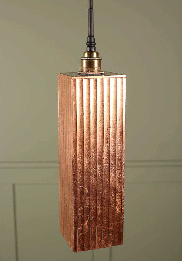 Elongated rectangular copper leaf bathroom pendant light with brushed brass lamp holder.